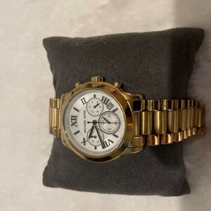 Michael Kors oversized gold watch with white face and black numerals